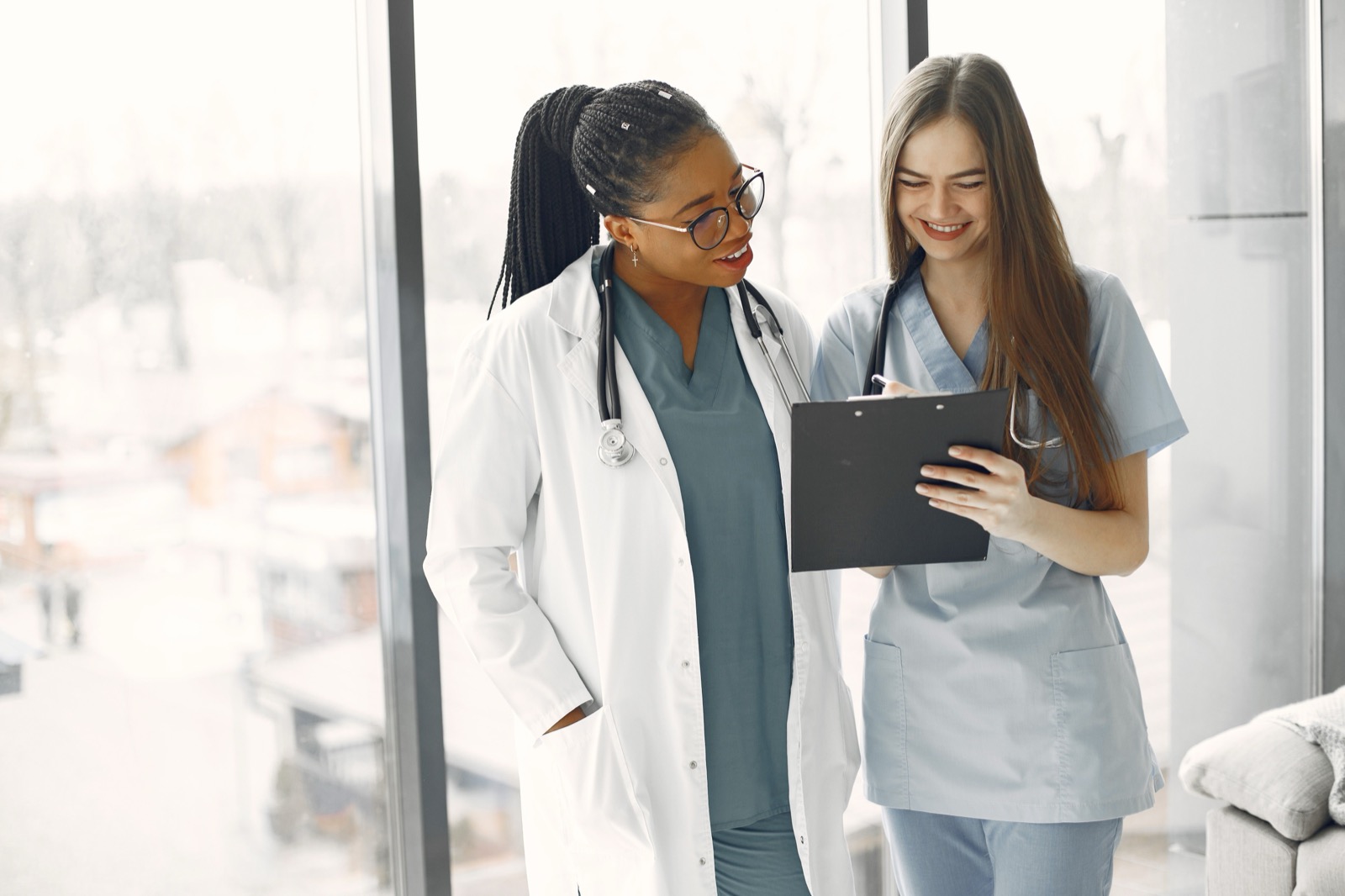Two healthcare professionals reviewing a document together
