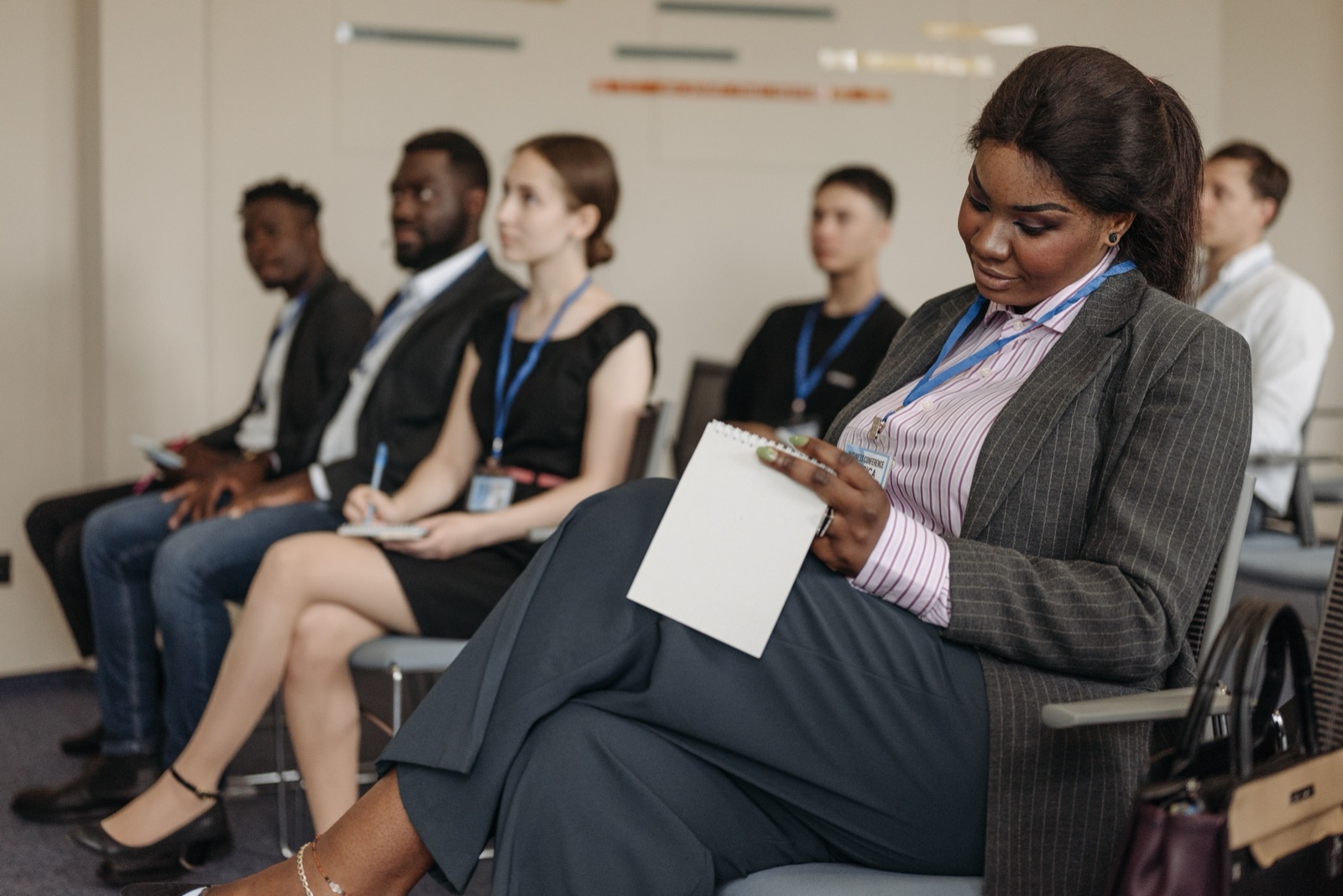 Professionals taking notes during a workplace seminar